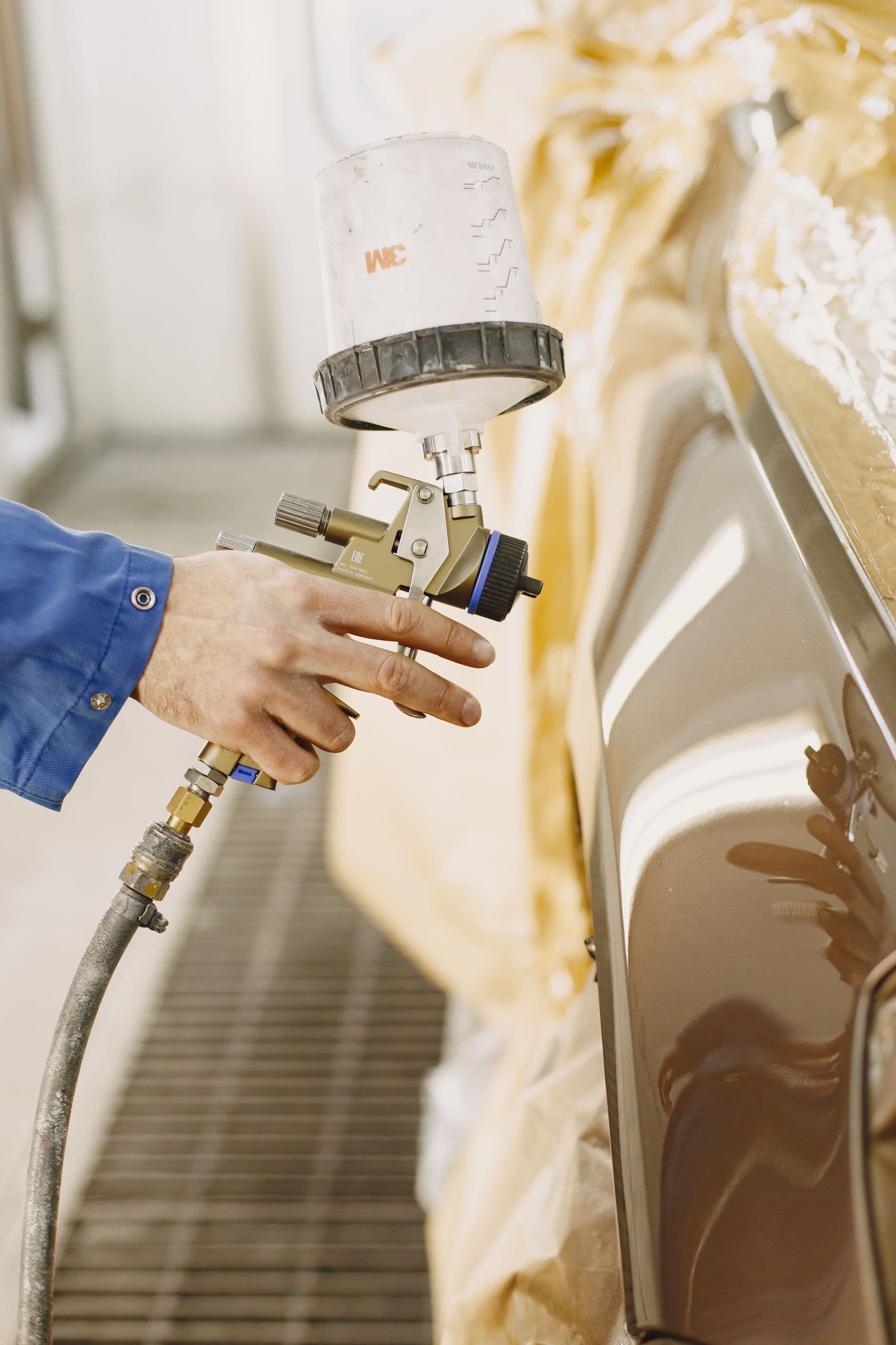 Paint finish being inspected under workshop light